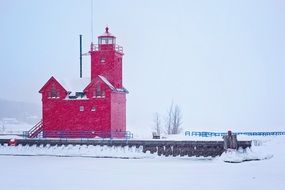 pink lighthouse in michigan in winter