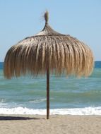 unusual beach umbrella on the shores of the Mediterranean Sea