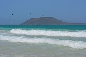 Sragulls over seashore waves