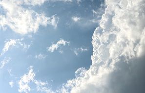 blue sunny sky with white fluffy clouds