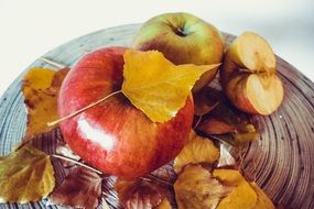 fresh apples with autumn leaves close