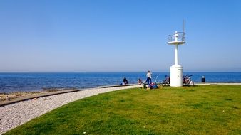 people near the white lighthouse