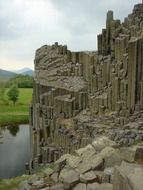 rocks on the river bank under a cloudy sky