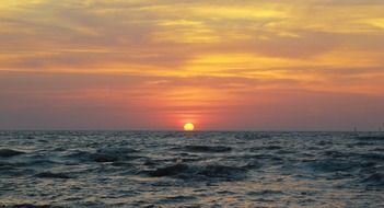 ocean waves at the sunset