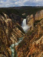 scenic lower falls and stream in valley of gorge canyon, usa, wyoming, yellowstone national park