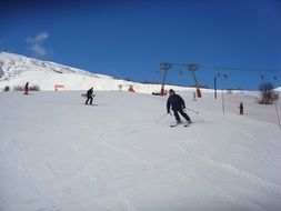 landscape of skiers on the snowy track on a sunny day