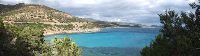 landscape of turquoise water near a hill in sardinia