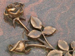 stone graceful rose on a tombstone