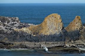 scenic grey rocks above blue water
