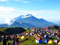 tourists and colorful tents in view of mountains, Indonesia