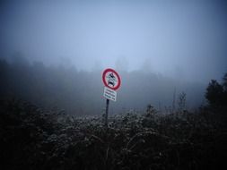 warning sign on the road in the fog