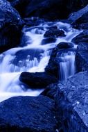 blue water cascade at dusk