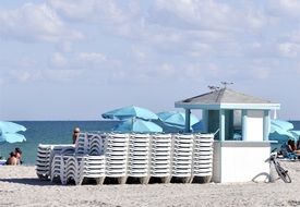 white deck chairs on the beach in florida