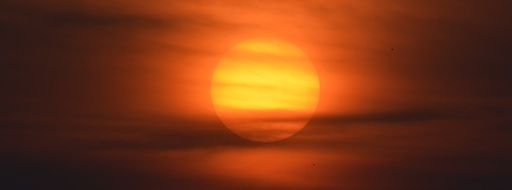 setting orange sun in haze