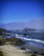 grey rocks and boulders on beach at sea, usa, oregon