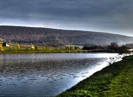 Lake near green hills