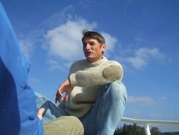 young man on a boat on a sunny day