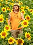 hippie, young caucasian man in sunflowers