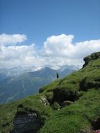 hike to the top of a green hill