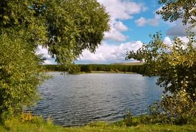 panorama of the lake between the trees