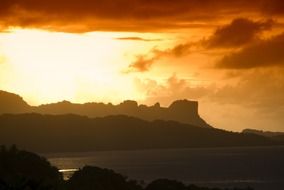 sunset over the mountains in micronesia