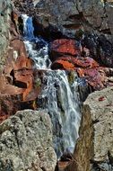 Waterfall against a rocky landscape