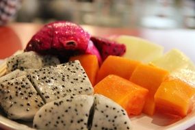 organic fresh fruits on the plate closeup