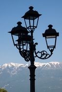 street lamp on the background of a mountain in the snow