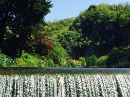 wide even waterfall among green forest