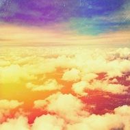 white clouds on orange sky view from airplane window