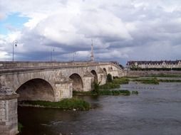 landscape of stone bridge over the loira river in france