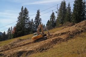 dredging machine on the ski run in summer