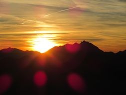 bright orange sunset over the alpine mountains