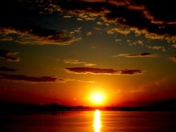golden reflection of the sun at sunset over the lake