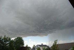 black rain clouds over the trees