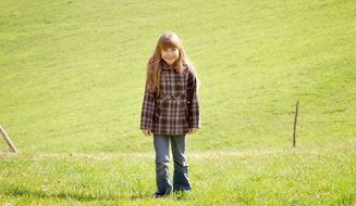 girl with long hair in a meadow