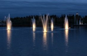 evening lighting fountains on the lake