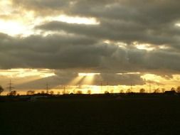 sunbeams through dark clouds