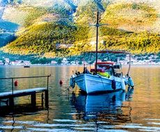 fishing boat near the pier in picturesque greece