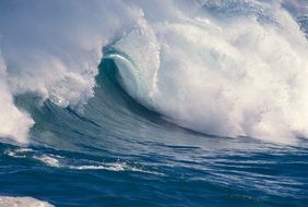 big waves of blue ocean with white foam