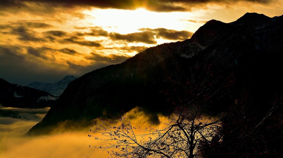 yellow sunrise over the mountains in the haze