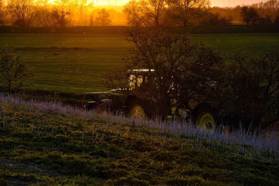 tractor on the field at sunset