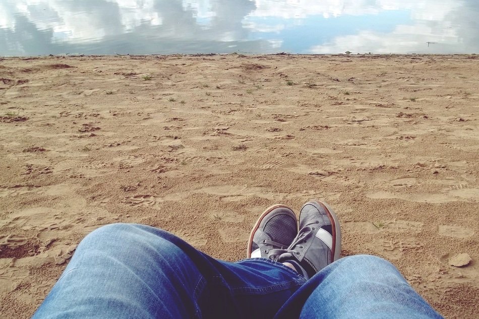 legs rest mirroring sand