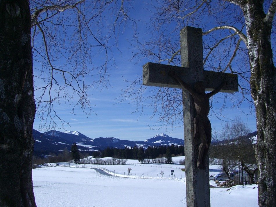 stone cross on a background of mountains
