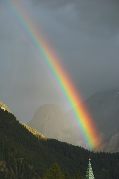 rainbow over the mountain during rain