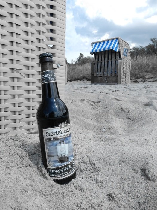 dark beer on the beach of the Baltic Sea