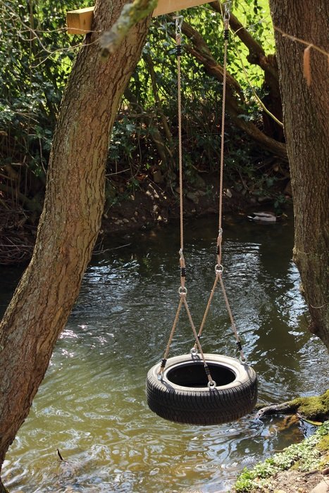 swing made from tire on trees