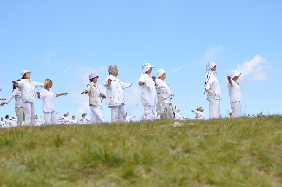 people in white clothes on the mountain
