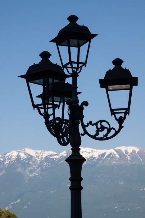 street lamp on the background of a mountain in the snow