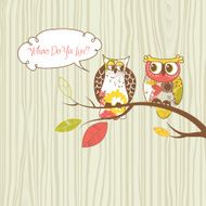 Two pretty owls sitting on the branch
